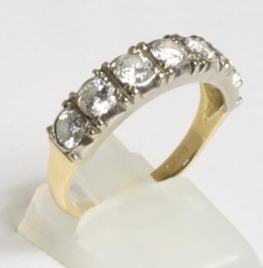 A SEVEN STONE DIAMOND HALF HOOP RING Image