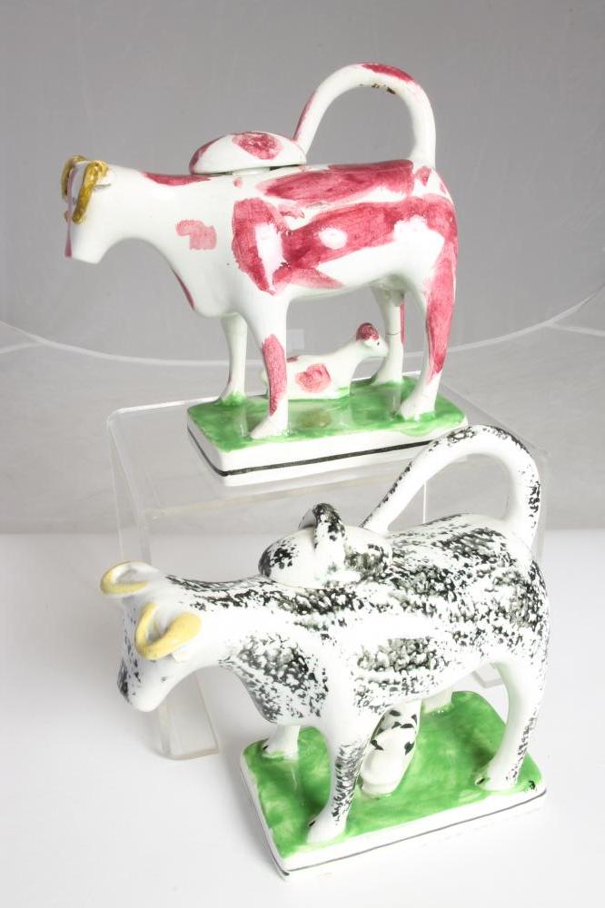 TWO SIMILAR STAFFORDSHIRE POTTERY COW CREAMERS AND COVERS Image
