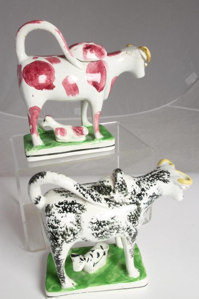 TWO SIMILAR STAFFORDSHIRE POTTERY COW CREAMERS AND COVERS Image