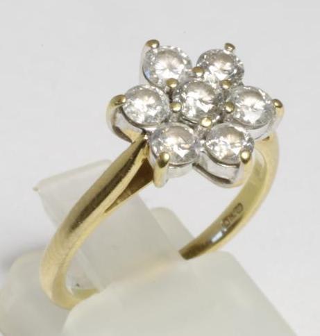 A SEVEN STONE DIAMOND CLUSTER RING Image