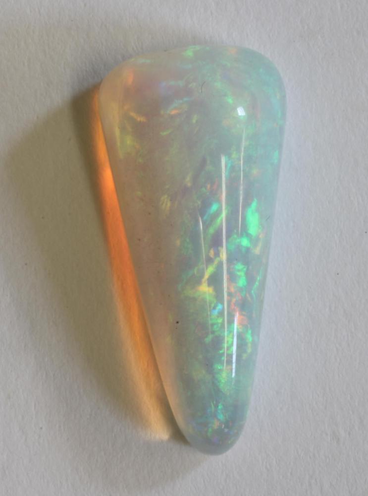 A POLISHED OPAL of triangular form and of approximately 15cts Image