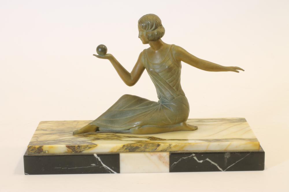 AN ART DECO BRONZED SPELTER FIGURE of a young lady wearing a long draped dress Image