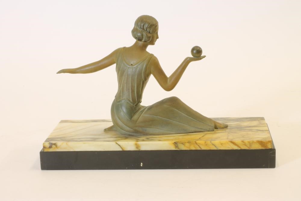 AN ART DECO BRONZED SPELTER FIGURE of a young lady wearing a long draped dress Image