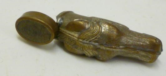 A VICTORIAN BRASS NOVELTY VESTA stamped as a horse's head with hinged cover/strike Image