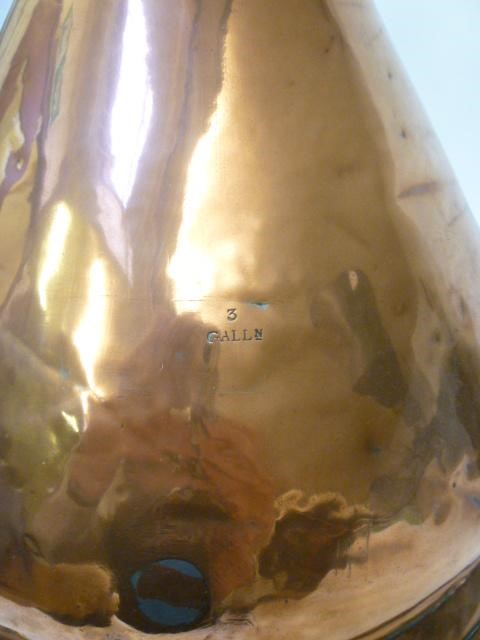 A THREE GALLON COPPER MEASURE of typical haystack form with moulded base Image
