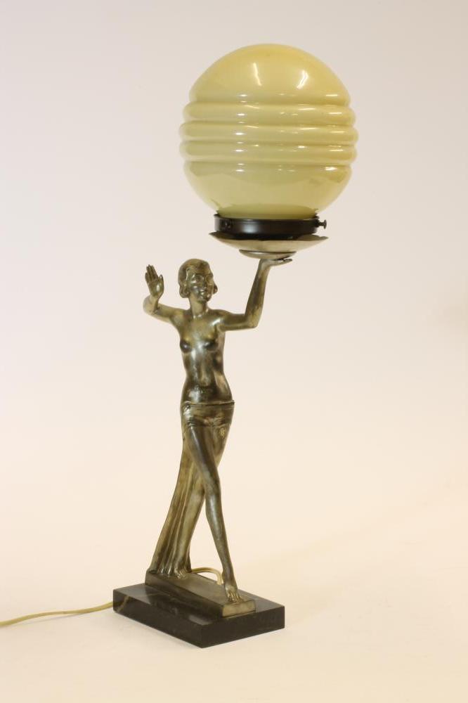AN ART DECO SILVERED SPELTER FIGURAL TABLE LAMP of a semi-nude girl in an Egyptianesque stance Image