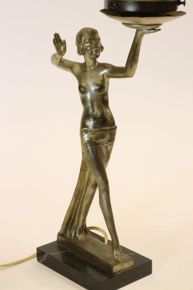 AN ART DECO SILVERED SPELTER FIGURAL TABLE LAMP of a semi-nude girl in an Egyptianesque stance Image