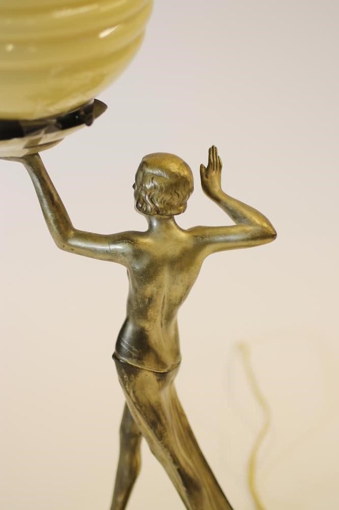 AN ART DECO SILVERED SPELTER FIGURAL TABLE LAMP of a semi-nude girl in an Egyptianesque stance Image