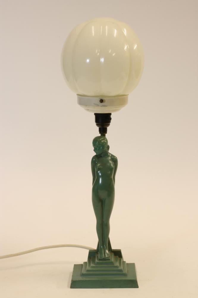 AN ART DECO FIGURAL TABLE LAMP of a naked young girl standing beside a post on a stepped base Image