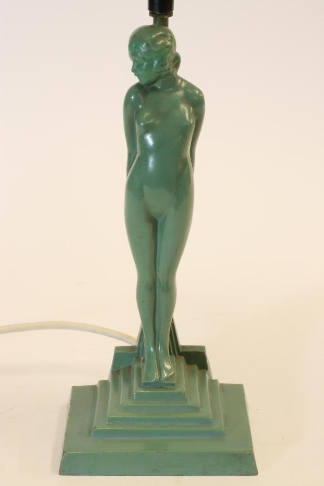 AN ART DECO FIGURAL TABLE LAMP of a naked young girl standing beside a post on a stepped base Image