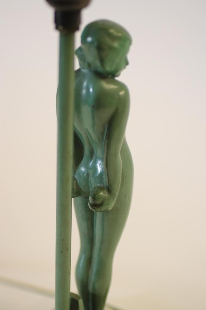 AN ART DECO FIGURAL TABLE LAMP of a naked young girl standing beside a post on a stepped base Image