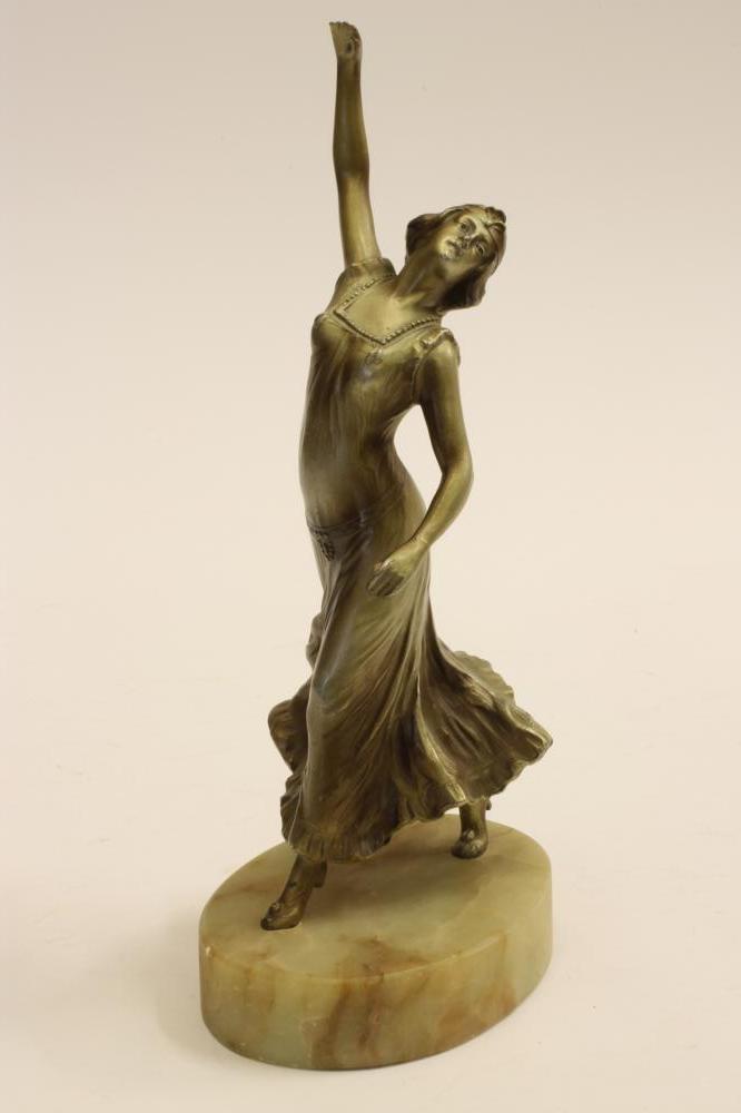 AN ART DECO SILVERED SPELTER FIGURE of a female dancer wearing a flowing dress Image