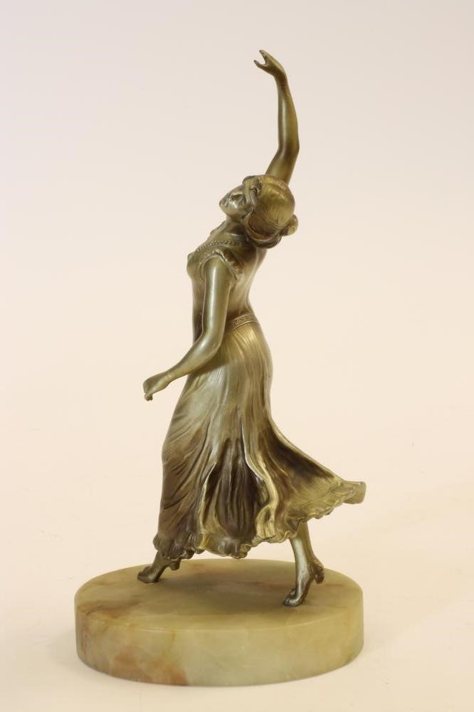 AN ART DECO SILVERED SPELTER FIGURE of a female dancer wearing a flowing dress Image