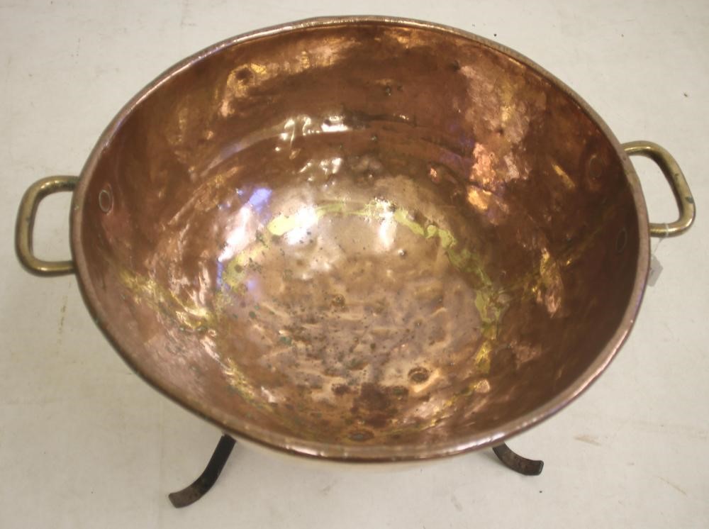 A VICTORIAN COPPER PAN of circular round bottomed form Image