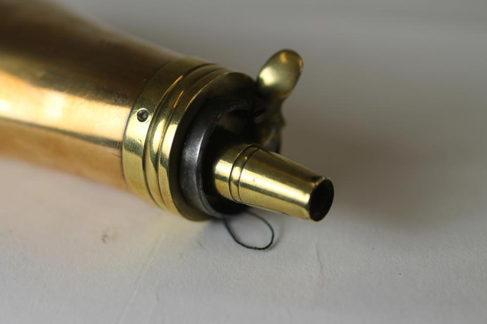 A BRASS PISTOL POWDER FLASK BY SYKES Image