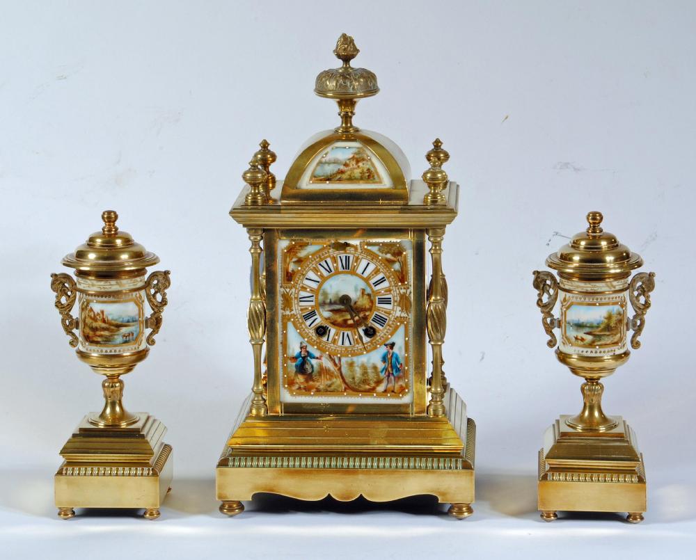 A FRENCH BRASS AND PORCELAIN MANTEL CLOCK GARNITURE Image
