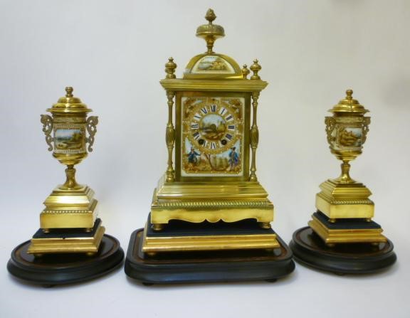 A FRENCH BRASS AND PORCELAIN MANTEL CLOCK GARNITURE Image
