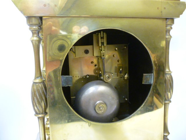 A FRENCH BRASS AND PORCELAIN MANTEL CLOCK GARNITURE Image