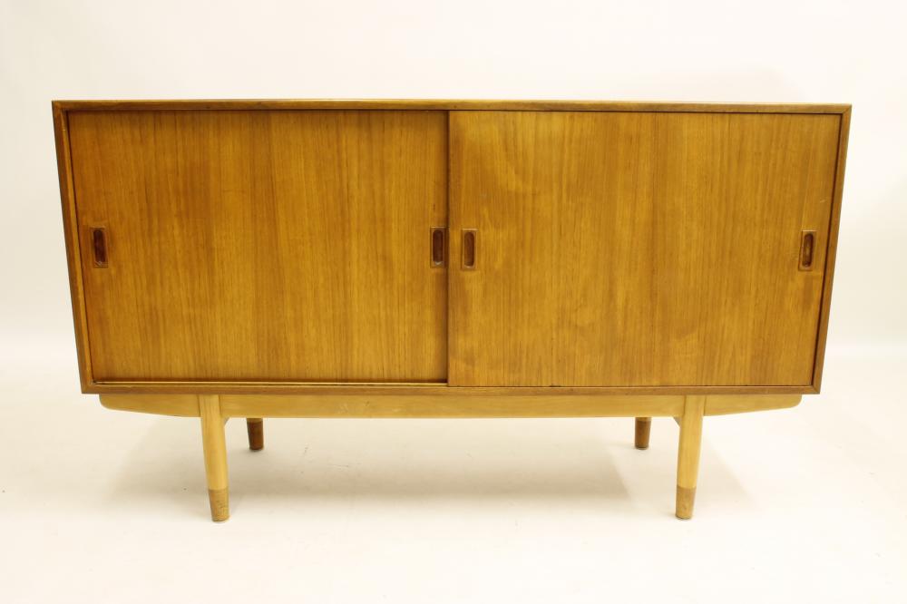 A DANISH BORGE MOGENSEN TEAK SIDEBOARD of oblong form with two sliding doors bearing lug handles and Image