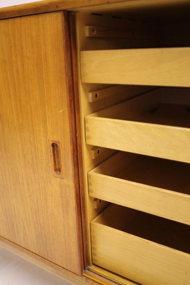 A DANISH BORGE MOGENSEN TEAK SIDEBOARD of oblong form with two sliding doors bearing lug handles and Image