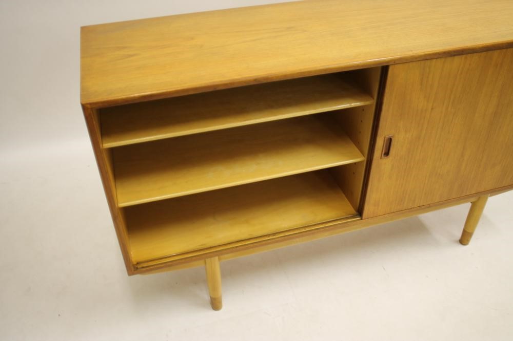 A DANISH BORGE MOGENSEN TEAK SIDEBOARD of oblong form with two sliding doors bearing lug handles and Image