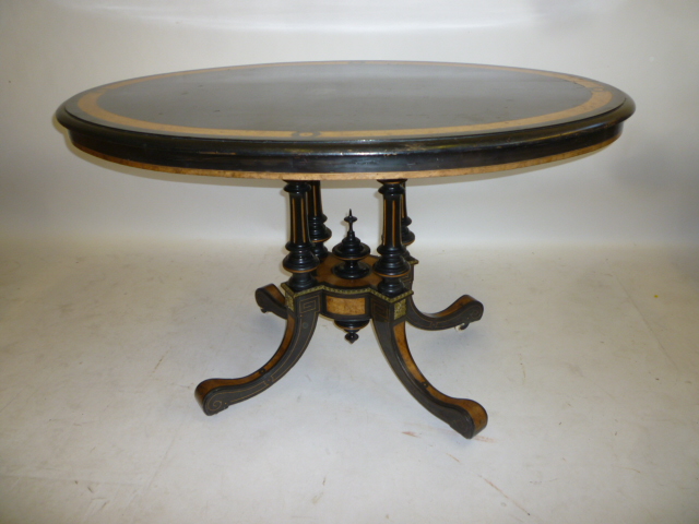 A VICTORIAN EBONOISED AND AMBOYNA LOO TABLE with gilt metal mounts Image