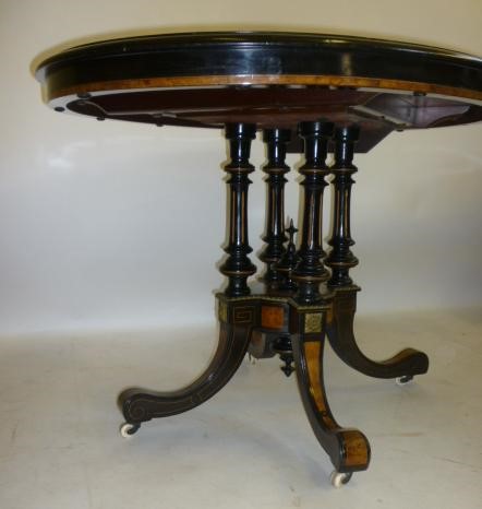 A VICTORIAN EBONOISED AND AMBOYNA LOO TABLE with gilt metal mounts Image