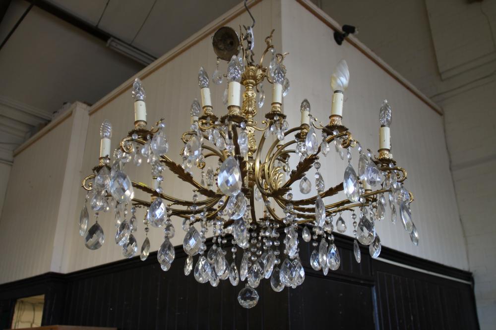 A GILT METAL AND GLASS CHANDELIER Image