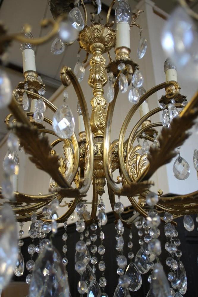 A GILT METAL AND GLASS CHANDELIER Image