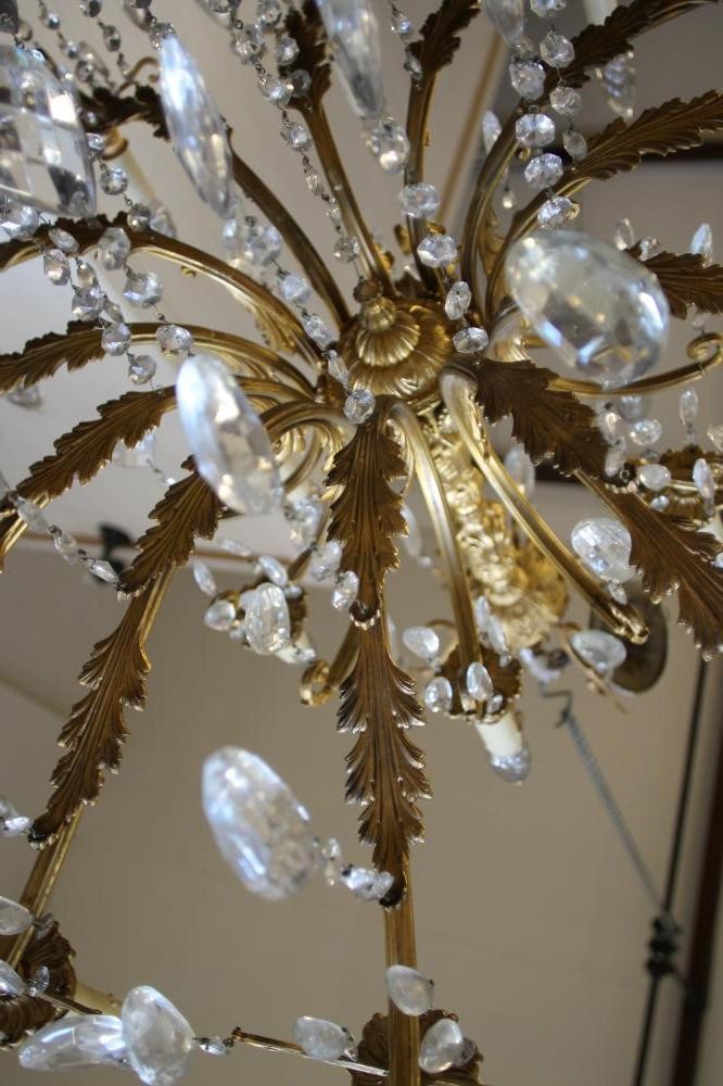 A GILT METAL AND GLASS CHANDELIER Image