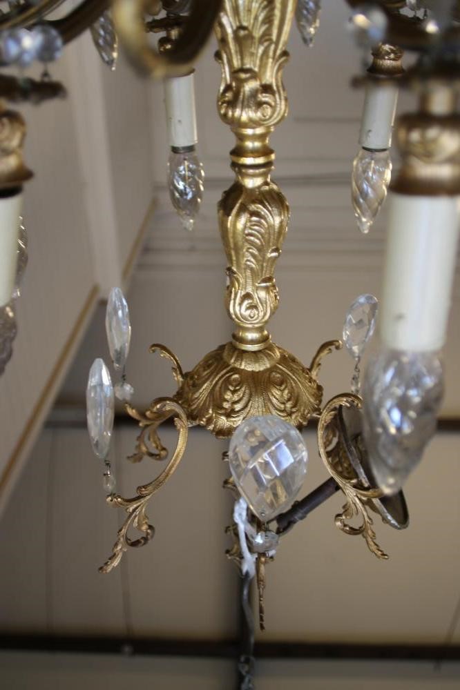 A GILT METAL AND GLASS CHANDELIER Image