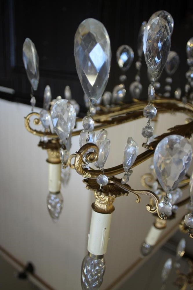 A GILT METAL AND GLASS CHANDELIER Image