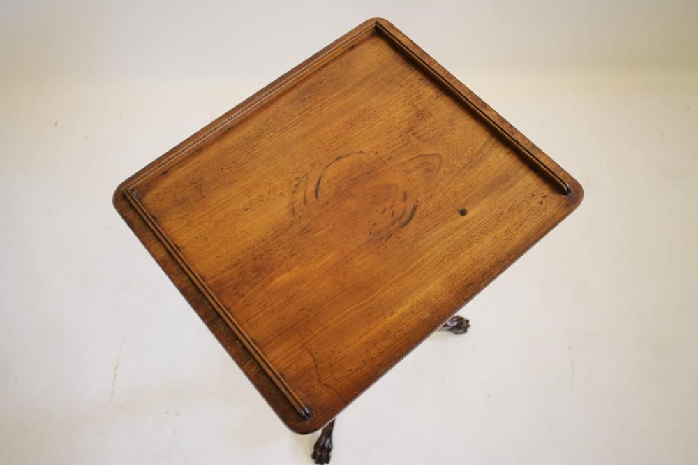 AN EARLY VICTORIAN MAHOGANY TRIPOD TABLE of rounded oblong form with three quarter gallery Image