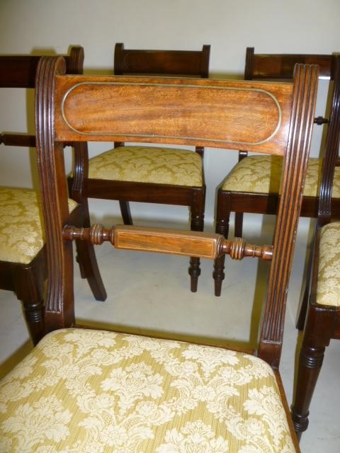A SET OF SIX REGENCY MAHOGANY DINING CHAIRS with brass stringing Image