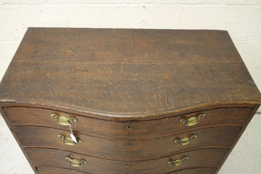 A GEORGIAN OAK SERPENTINE FRONTED CHEST Image