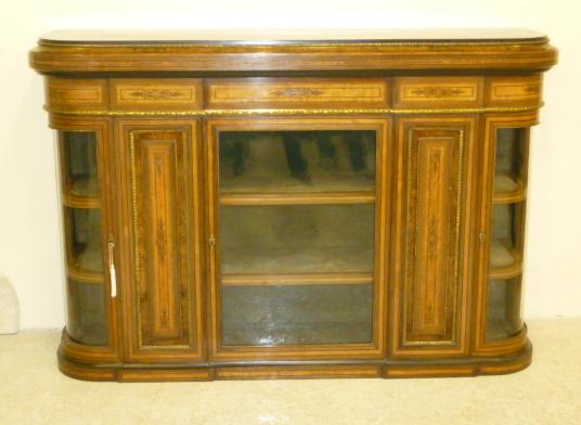 A VICTORIAN WALNUT AND EBONISED SIDE CABINET of rounded oblong form crossbanded with stringing and Image