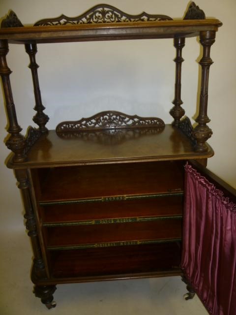 A VICTORIAN WALNUT MUSIC CABINET of rounded oblong form Image