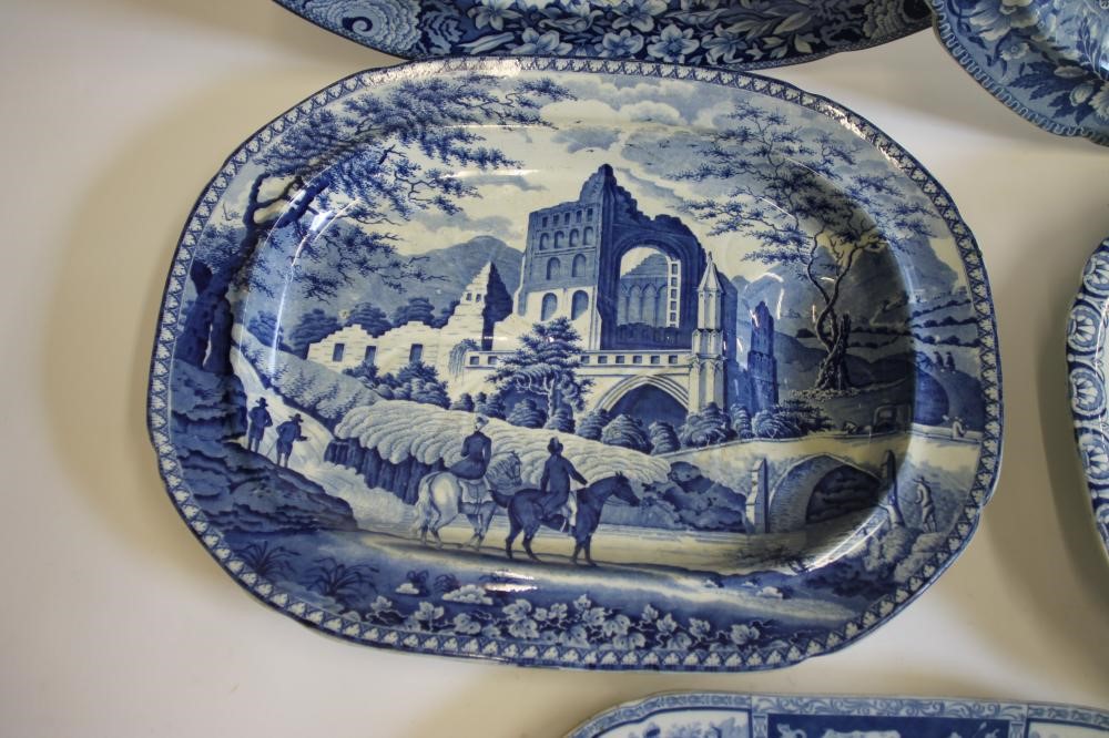 A COLLECTION OF FIVE BLUE AND WHITE PRINTED EARTHENWARE MEAT PLATES including Adams "Cowherds near Image