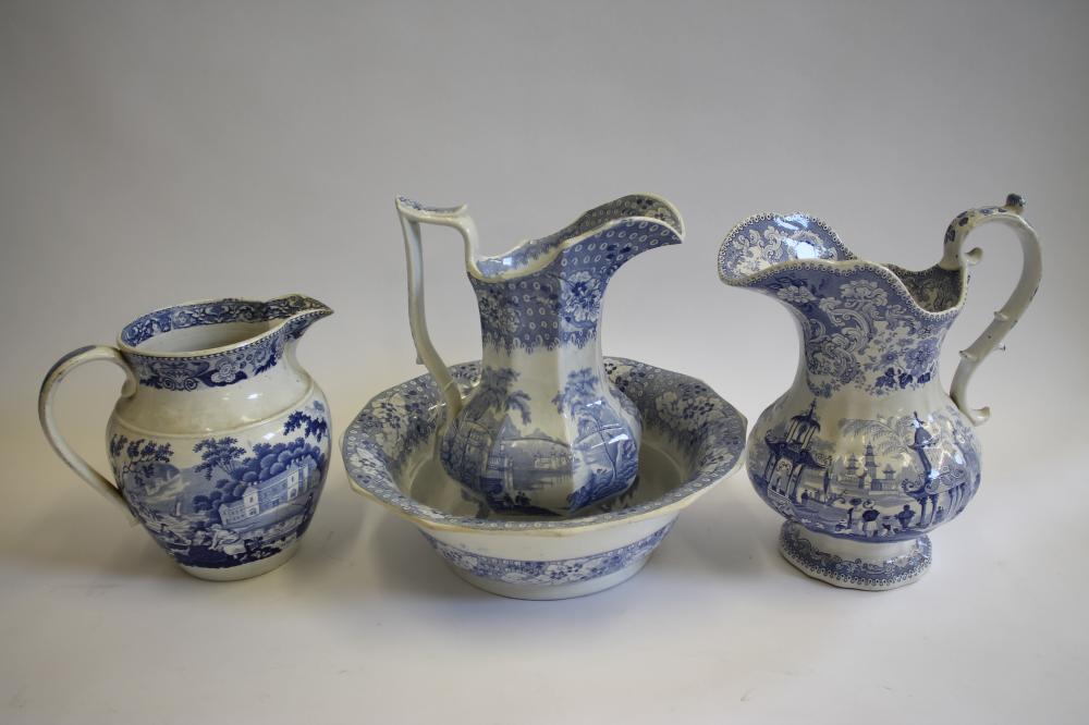 A COLLECTION OF SIX BLUE AND WHITE PRINTED EARTHENWARE JUGS Image