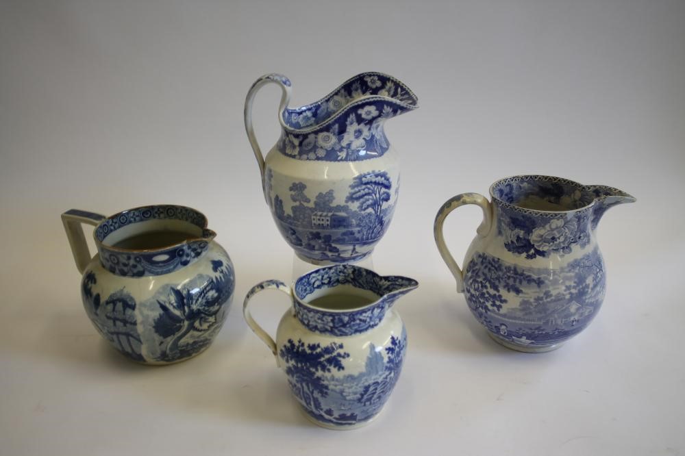 A COLLECTION OF SIX BLUE AND WHITE PRINTED EARTHENWARE JUGS Image