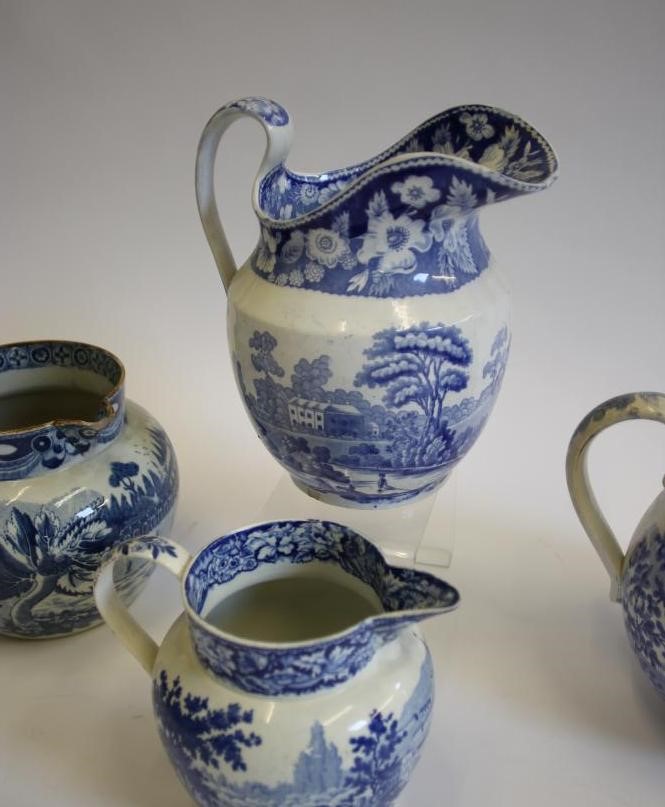 A COLLECTION OF SIX BLUE AND WHITE PRINTED EARTHENWARE JUGS Image