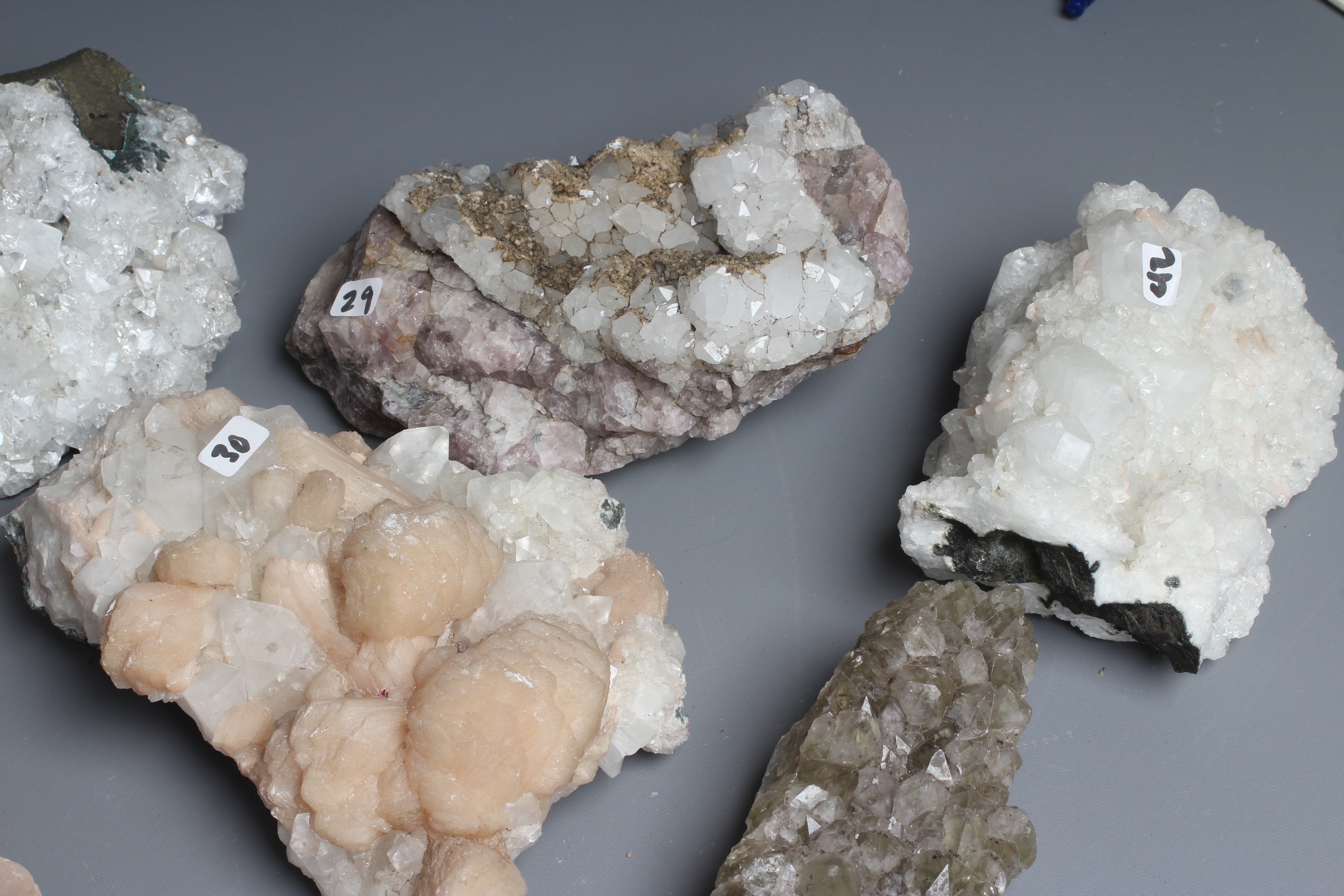 Eleven mineral samples, including quartz crystals, calcite growths ...