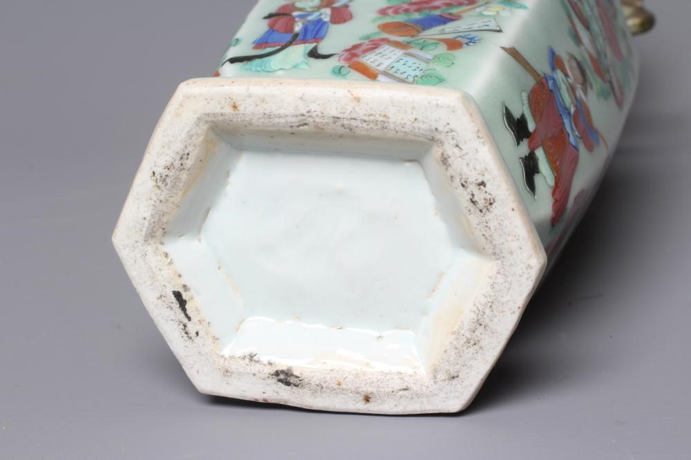 A CANTONESE PORCELAIN FAMILLE ROSE TWO HANDLED VASE of rounded hexagonal form, painted with figures Image