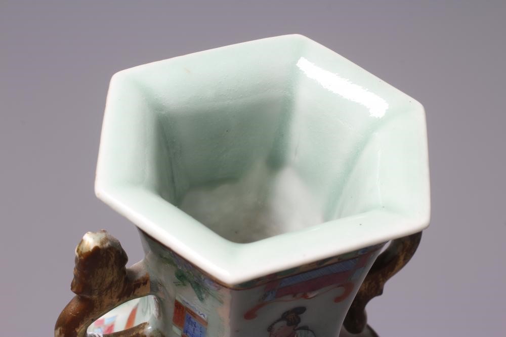 A CANTONESE PORCELAIN FAMILLE ROSE TWO HANDLED VASE of rounded hexagonal form, painted with figures Image
