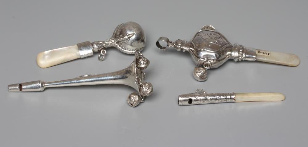 FOUR SILVER RATTLES comprising an Edwardian dumbell by Saunders & Shepherd Image