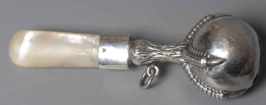 FOUR SILVER RATTLES comprising an Edwardian dumbell by Saunders & Shepherd Image