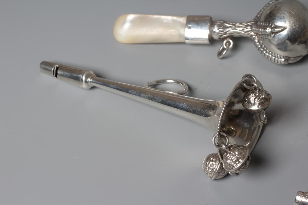 FOUR SILVER RATTLES comprising an Edwardian dumbell by Saunders & Shepherd Image