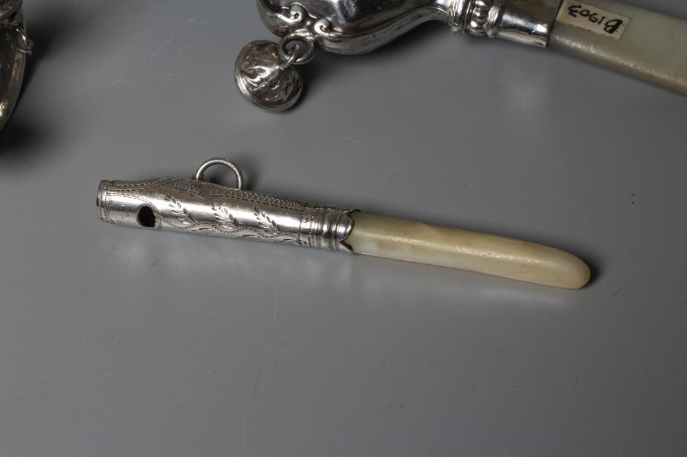 FOUR SILVER RATTLES comprising an Edwardian dumbell by Saunders & Shepherd Image
