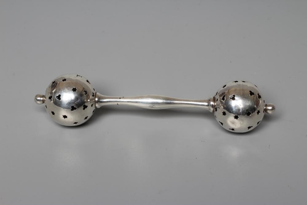 FOUR SILVER RATTLES comprising an Edwardian dumbell by Saunders & Shepherd Image