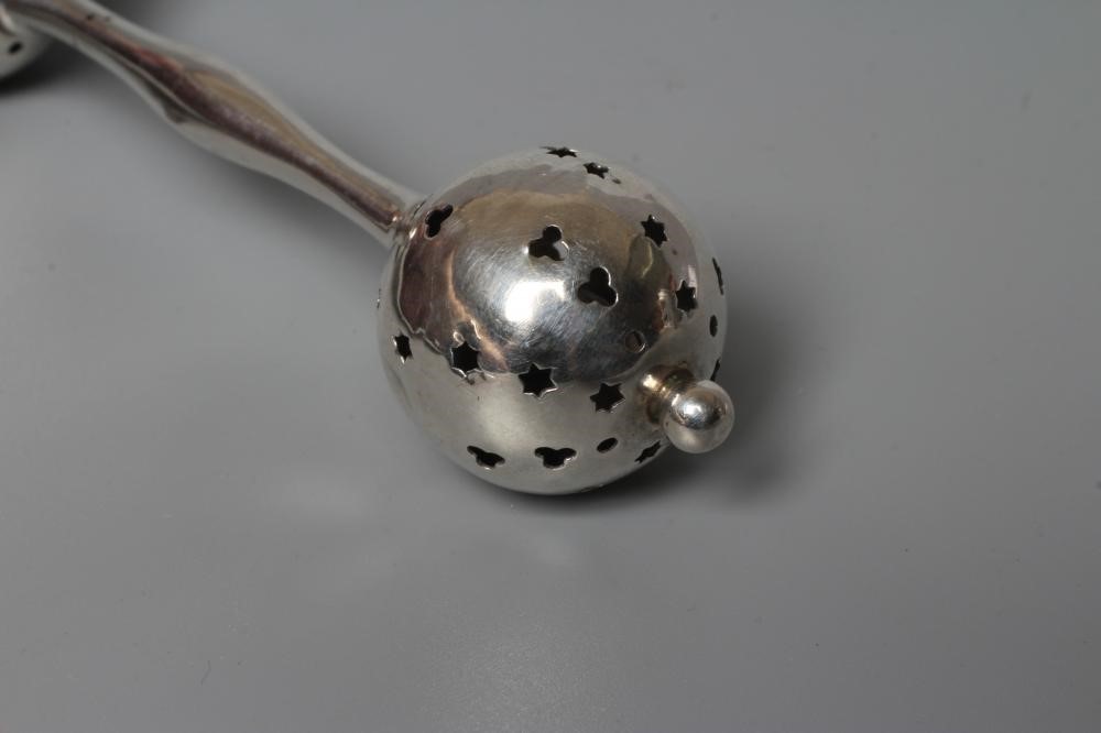 FOUR SILVER RATTLES comprising an Edwardian dumbell by Saunders & Shepherd Image